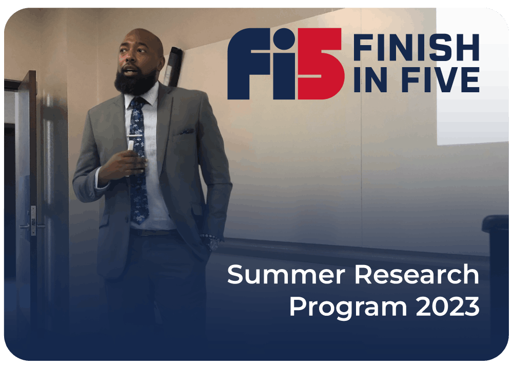 Well dressed student giving speech in front of classroom during Finish In Five's Summer Student Research 2023