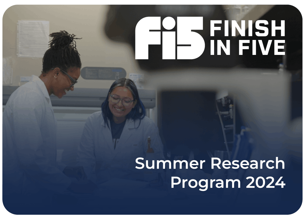 Two female students with lab coats smile together inside of a science lab surrounded by scientific equipment participating in Finish In Five's Summer Student Research 2024